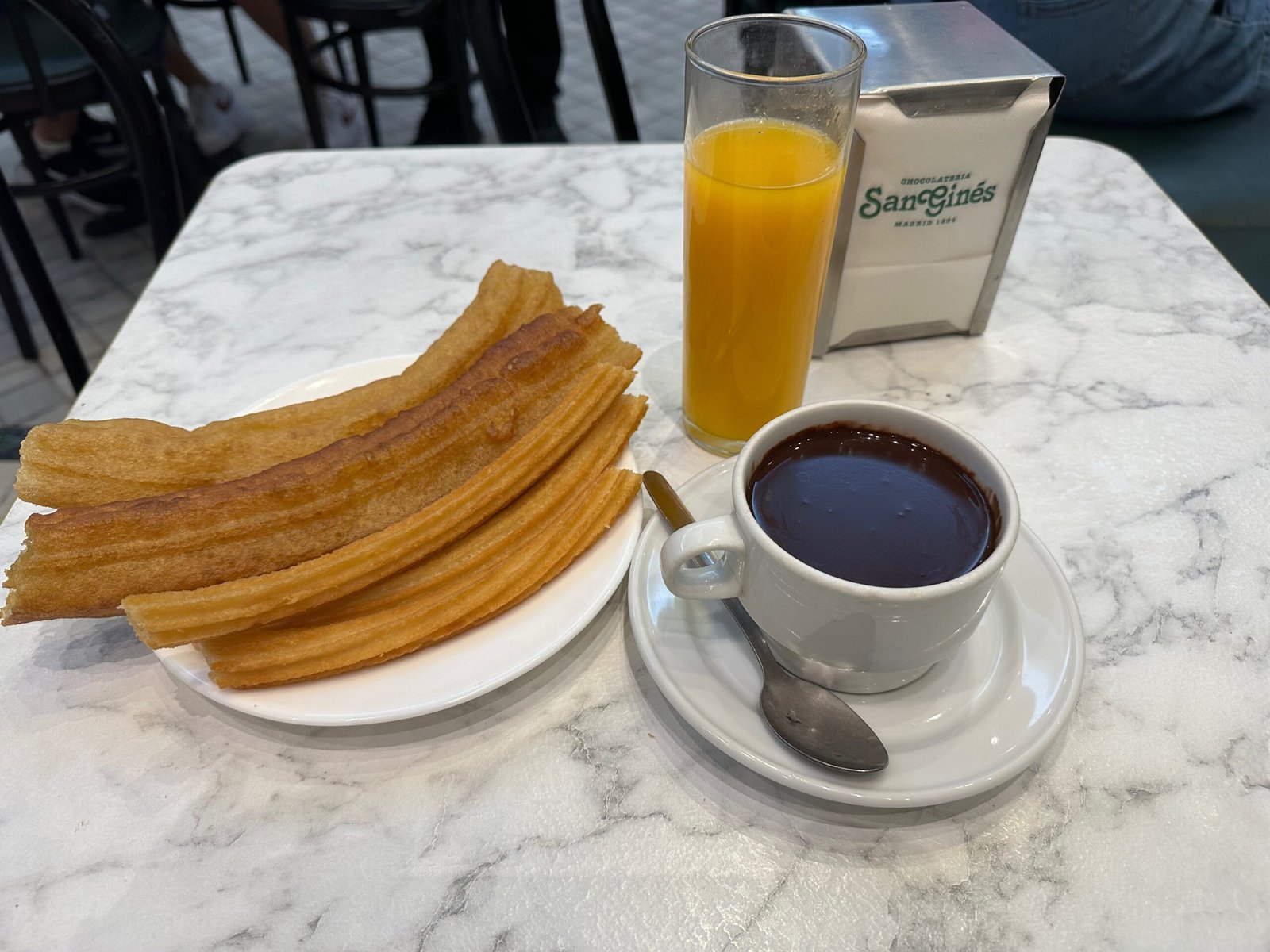 Spanish churros, hot chocolate, and glass of orange juice